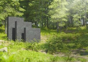 Dunkelgraue Schaumglasplatten von GLAPOR stehen in grünem Wald. 